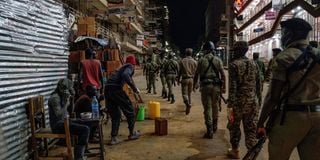 Ugandan police officers and members of Local Defence Units on curfew patrol in Kamapla in April 2020.