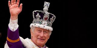 Britain's King Charles III wearing the Imperial State Crown, waves from the Buckingham Palace balcony